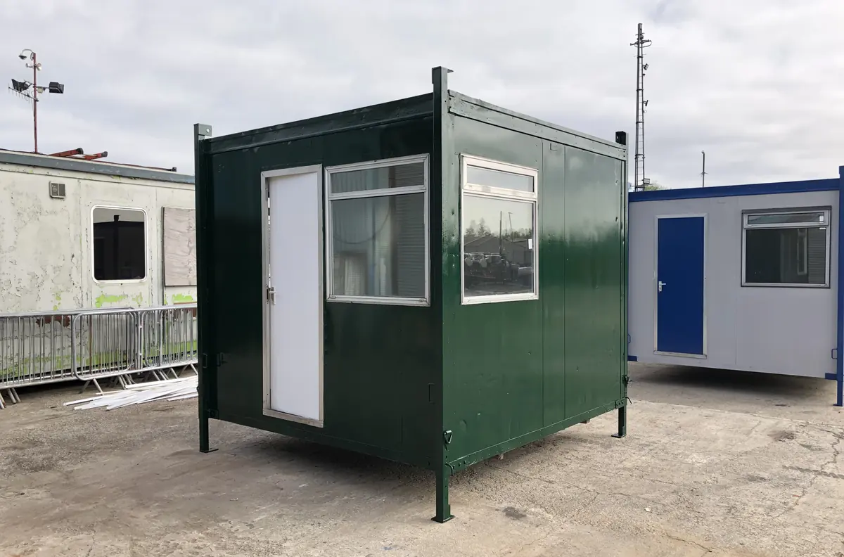 Row of used portable cabins stacked and stored in a hire company yard awaiting disposal