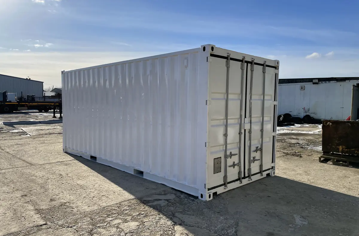 Used 20ft shipping container with doors open standing on concrete