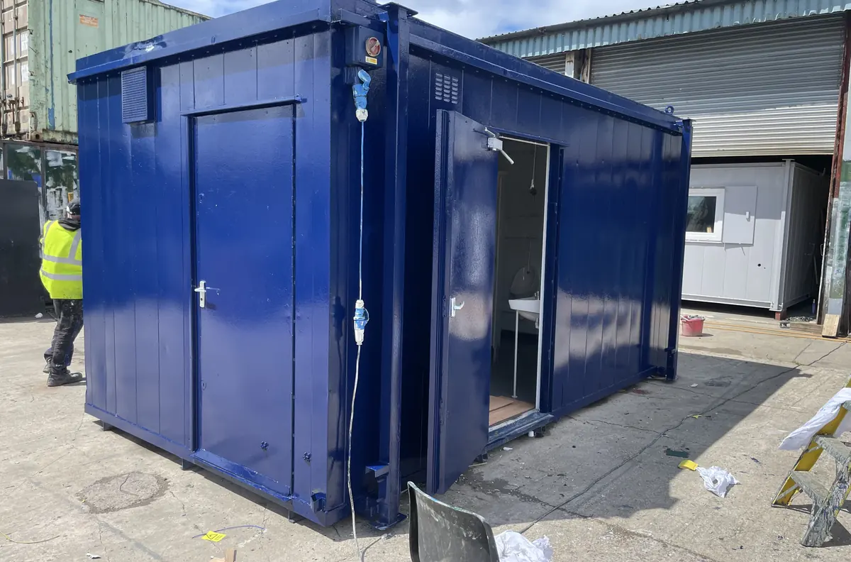 Used site toilet block with multiple cubicles and stainless steel wash trough